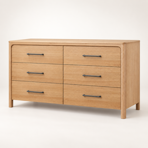 A light oak wood six-drawer dresser with dark metal bar handles, shown from a three-quarter angle against a clean white studio background.