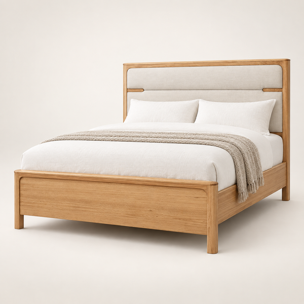 A modern wooden bed frame with a light beige upholstered headboard, styled with white bedding and a textured beige throw blanket, set against a plain off-white background.