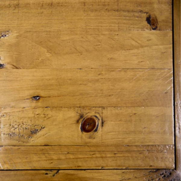 Close-up of a warm honey-toned wood surface made of horizontal planks with visible grain, knots, and slight wear marks.