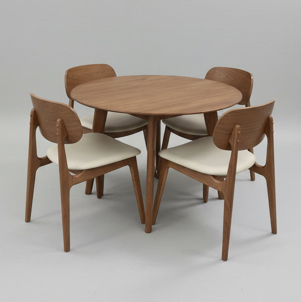 Wooden dining table with four matching chairs on a gray background