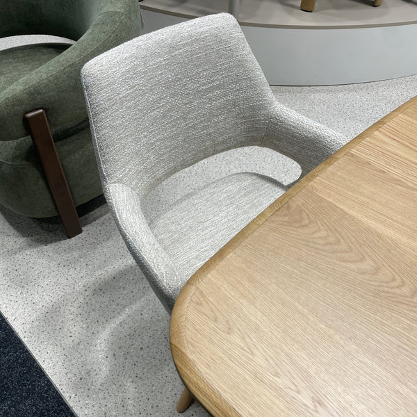 Dining chair with oatmeal textured fabric upholstery and dark wooden legs