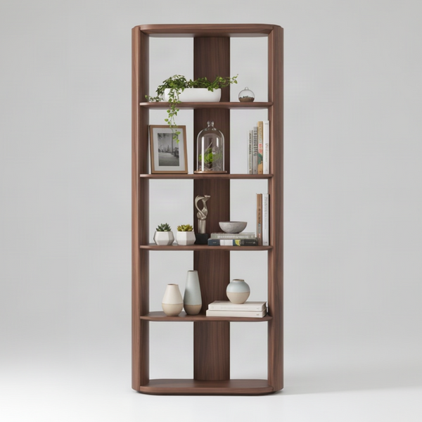 A tall, modern wooden bookcase with a warm medium-brown finish, featuring five open shelves and decorative items including books, vases, a small terrarium, and potted plants, set against a neutral light gray background.