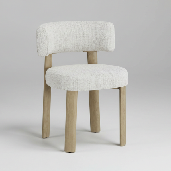 Light grey upholstered dining chair on a studio background, rounded backrest and front legs