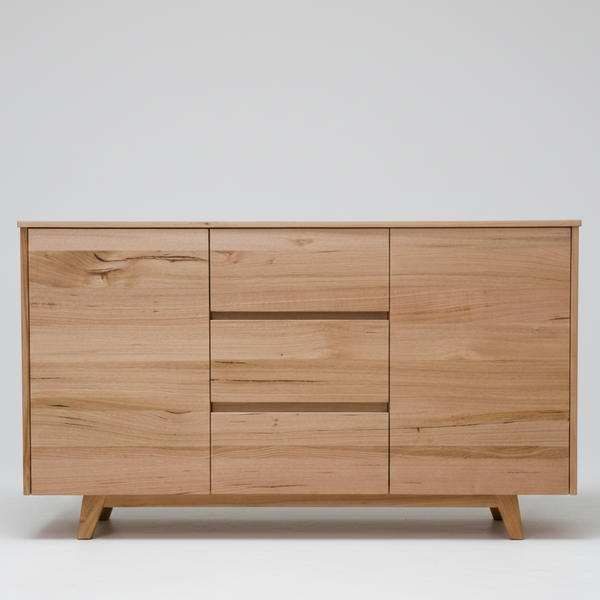 A mid-century modern wooden dresser with three drawers in the center and two larger cabinet doors on either side, finished in a light natural wood tone with visible grain patterns and supported by angled legs.