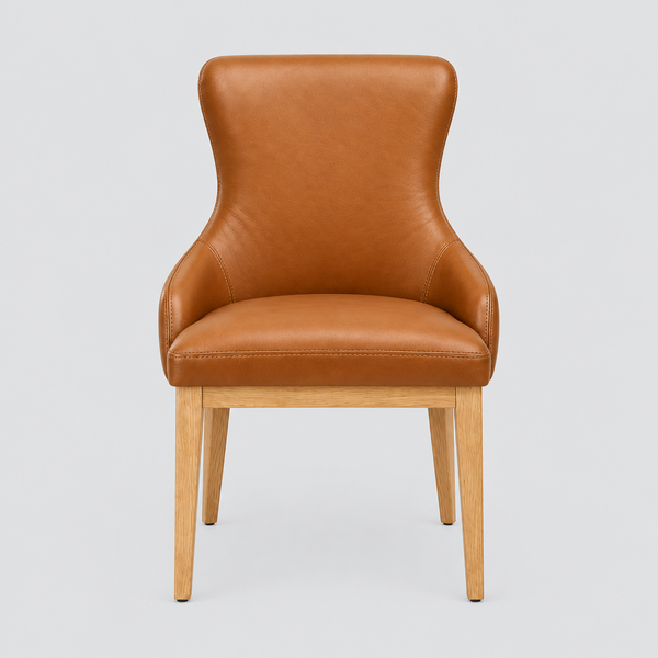 A modern accent chair with a warm caramel brown leather upholstered seat and backrest, supported by a light natural wood frame with tapered legs, shown against a solid light gray background.