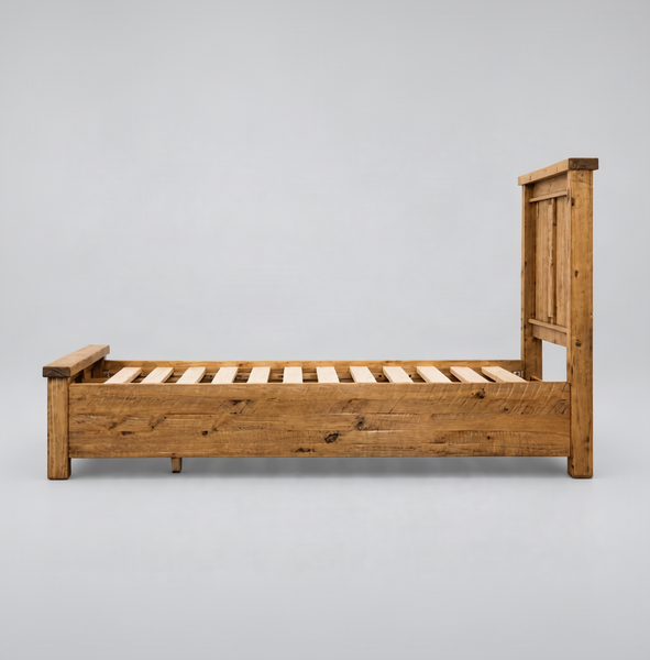 A rustic wooden single bed frame with a slatted base and a tall slatted headboard, shown from a side profile view against a plain white background.